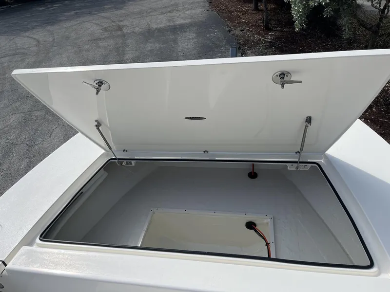 Slide: The Image of 2024 Hewes Redfisher 21 boat storage compartment open, showcasing spacious interior. - 16