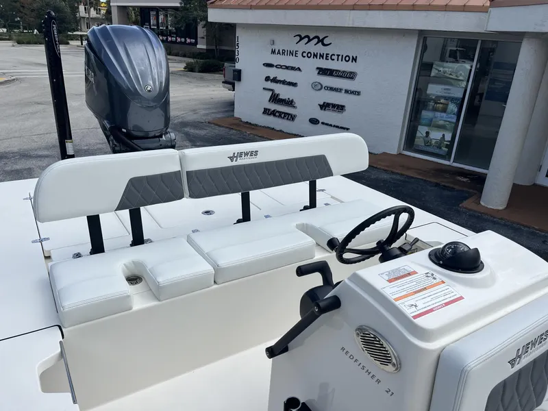 Slide: The Image of 2024 Hewes Redfisher 21 boat interior with seating and steering wheel at Marine Connection. - 17