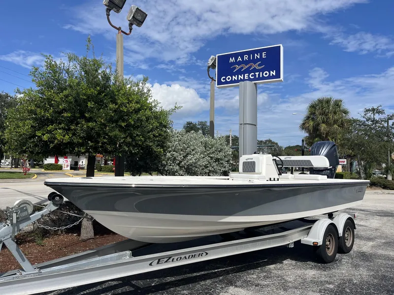 Slide: The Image of 2024 Hewes Redfisher 21 boat on trailer at Marine Connection dealership. - 2