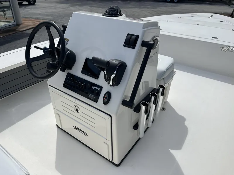 Slide: The Image of 2024 Hewes Redfisher 21 boat console with steering wheel and controls. - 22