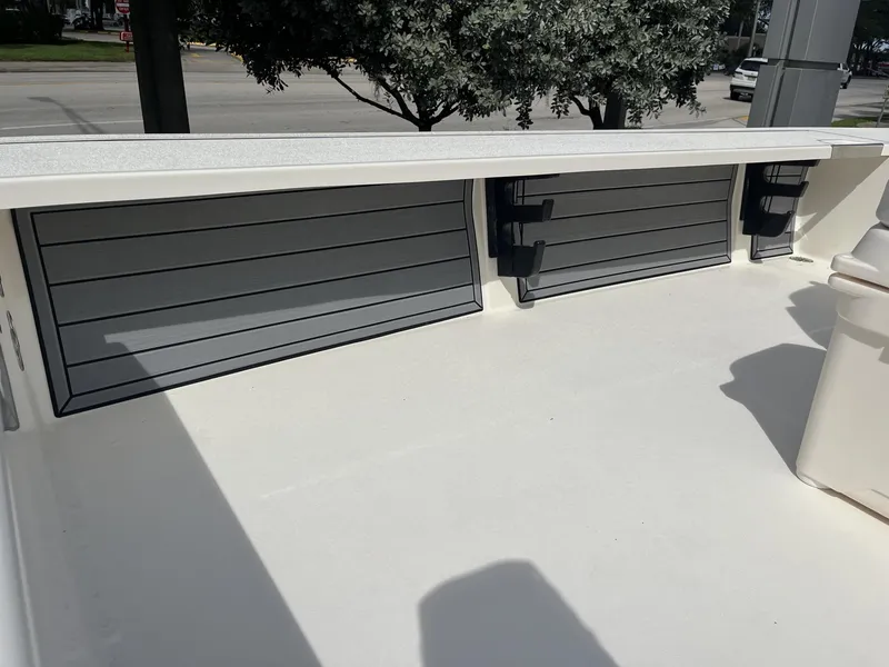 Slide: The Image of 2024 Hewes Redfisher 21 boat deck with storage compartments and clean white surface. - 23