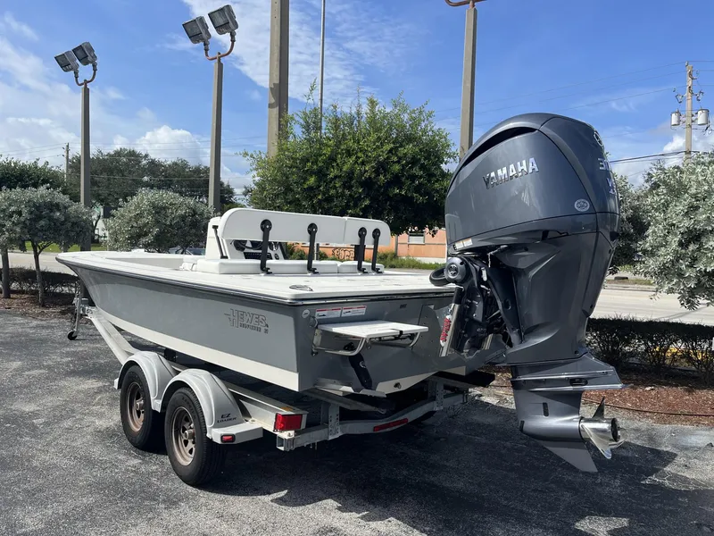 Slide: The Image of 2024 Hewes Redfisher 21 boat with Yamaha outboard motor on trailer. - 4