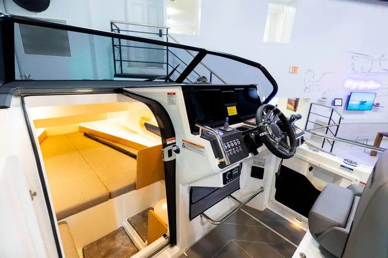 Slide: The Image of 2024 Quarken 27 T-Top V2 boat interior with modern helm and cozy cabin space. - 12