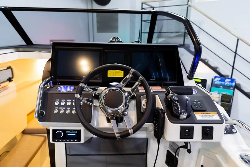 Slide: The Image of 2024 Quarken 27 T-Top V2 boat dashboard with modern controls and steering wheel. - 13