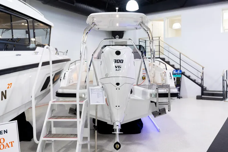 Slide: The Image of 2024 Quarken 27 T-Top V2 boat with powerful 300 V6 engine displayed indoors. - 3