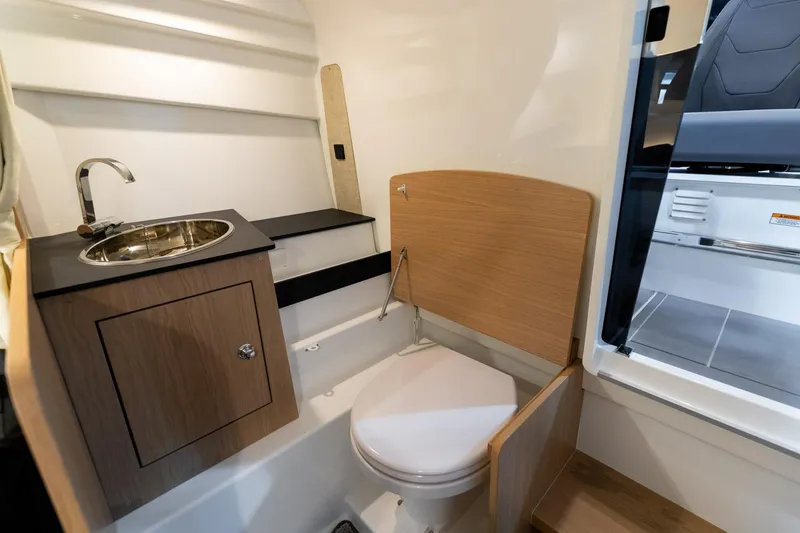 Slide: The Image of 2024 Quarken 27 T-Top V2 boat interior with compact bathroom and sink. - 23