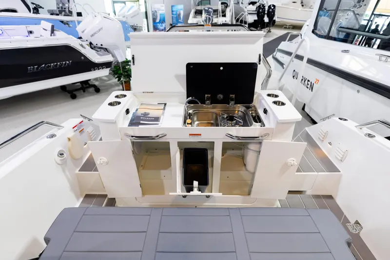 Slide: The Image of 2024 Quarken 27 T-Top V2 boat interior with kitchenette and storage compartments. - 8