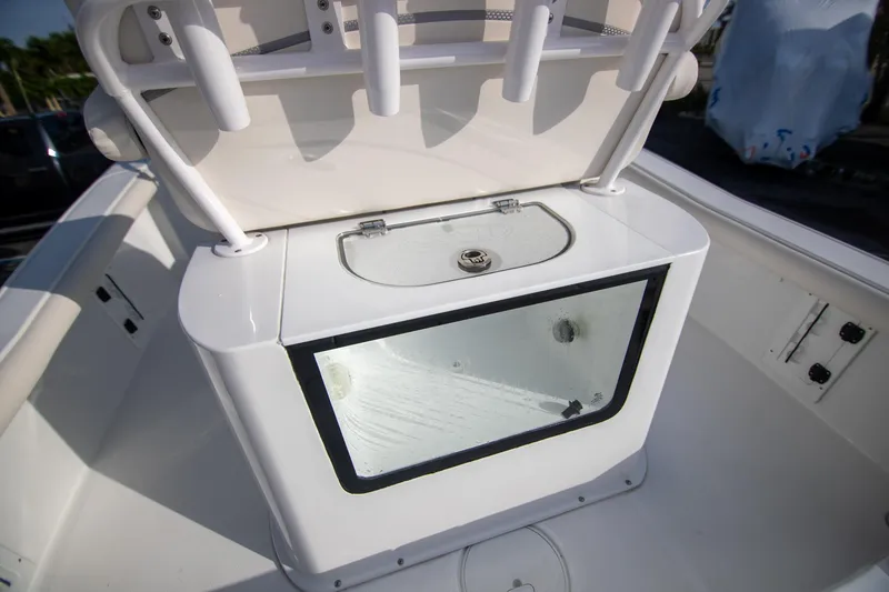 Slide: The Image of 2024 Sea Hunt BX 25 FS boat interior with storage compartment and rod holders. - 11