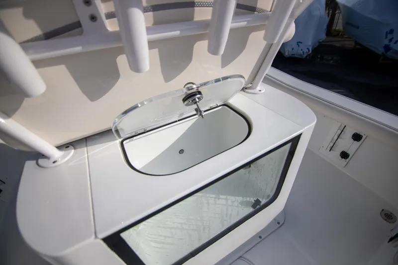 Slide: The Image of 2024 Sea Hunt BX 25 FS boat livewell with open lid, showcasing interior design. - 12