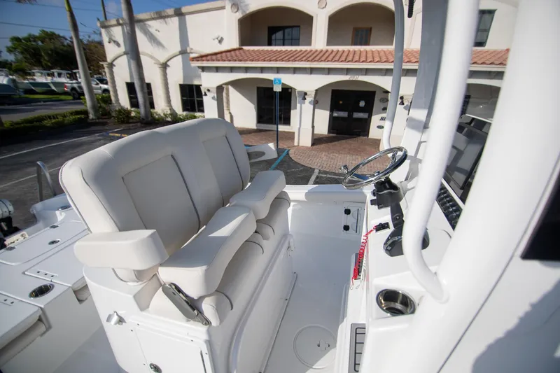Slide: The Image of 2024 Sea Hunt BX 25 FS boat interior with steering wheel and seating. - 13