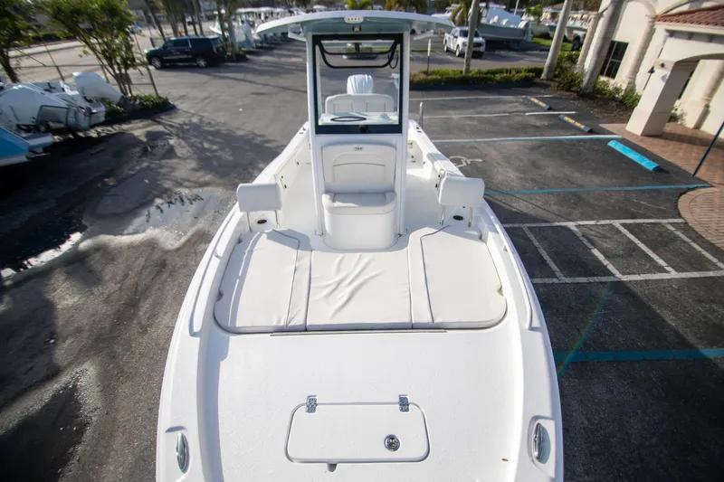 Slide: The Image of 2024 Sea Hunt BX 25 FS boat, spacious deck, parked outdoors. - 18