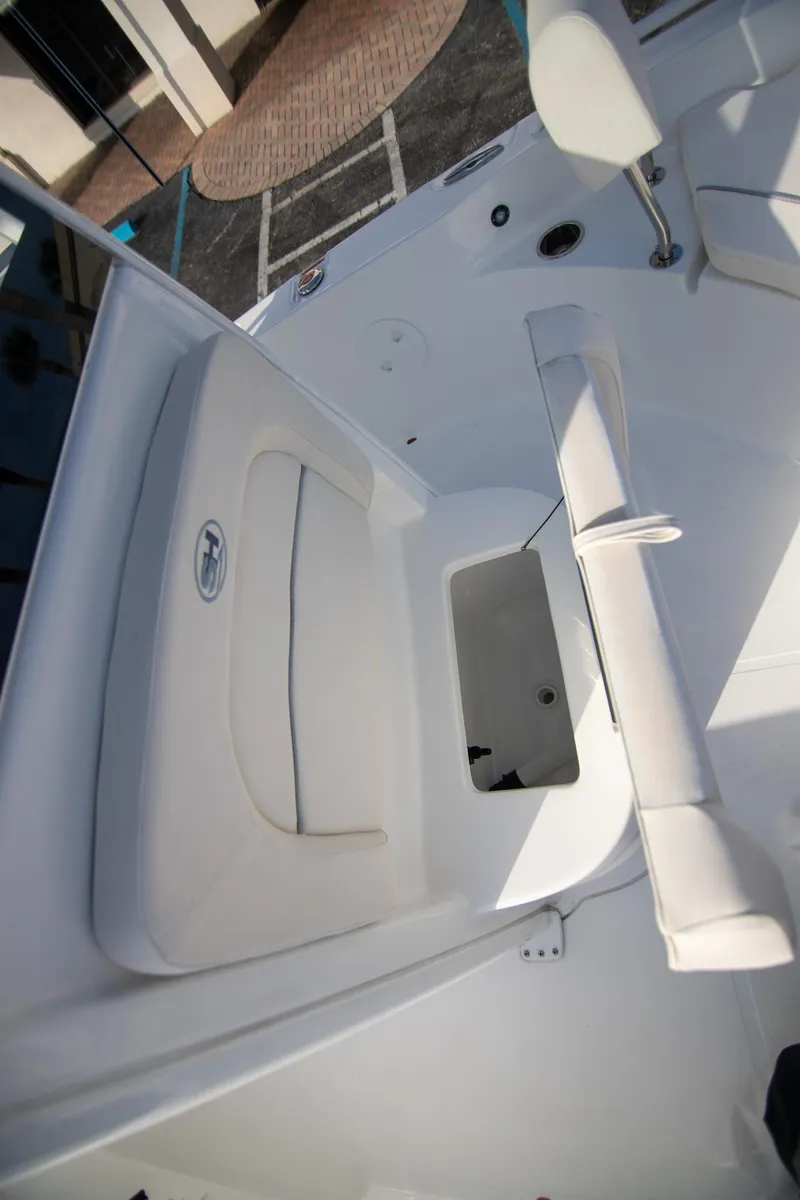 Slide: The Image of 2024 Sea Hunt BX 25 FS boat interior with seating and storage compartment. - 19