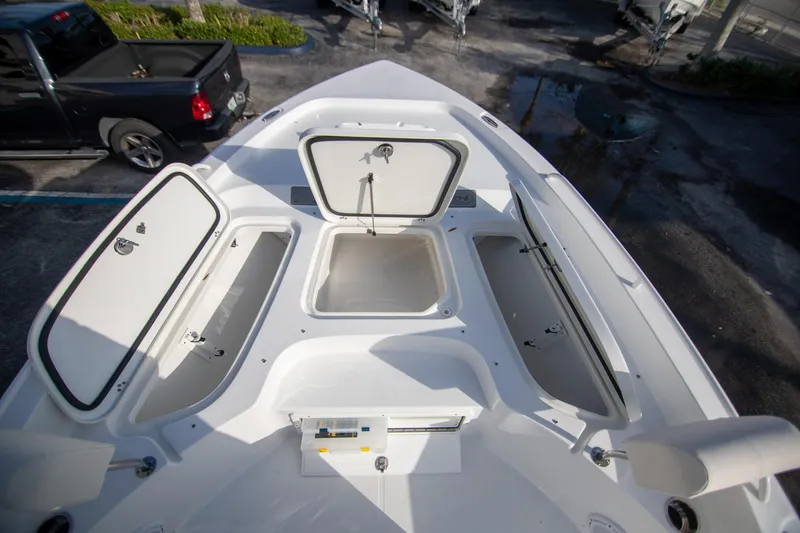 Slide: The Image of 2024 Sea Hunt BX 25 FS boat with open storage compartments on deck. - 21