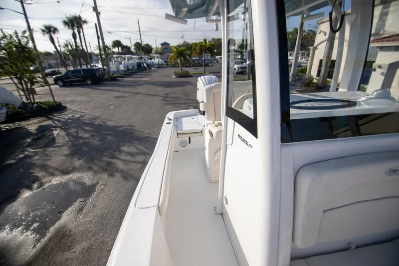 Slide: The Image of 2024 Sea Hunt BX 25 FS boat, side view, parked outdoors in a dealership lot. - 24
