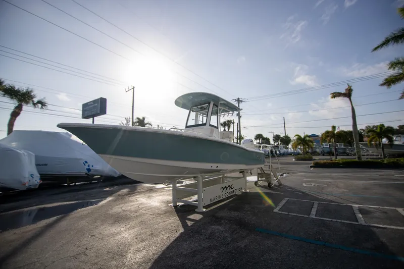 Slide: The Image of 2024 Sea Hunt BX 25 FS boat displayed outdoors under a sunny sky. - 5