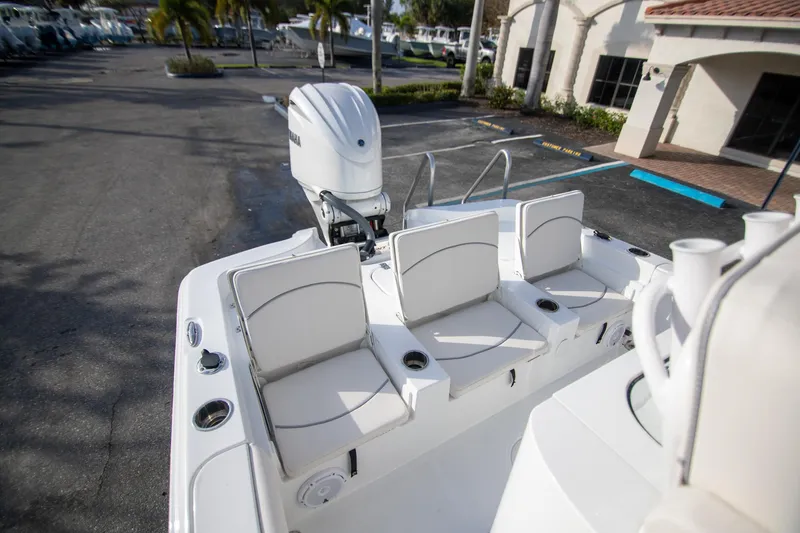 Slide: The Image of 2024 Sea Hunt BX 25 FS boat with white seating and Yamaha outboard motor. - 9