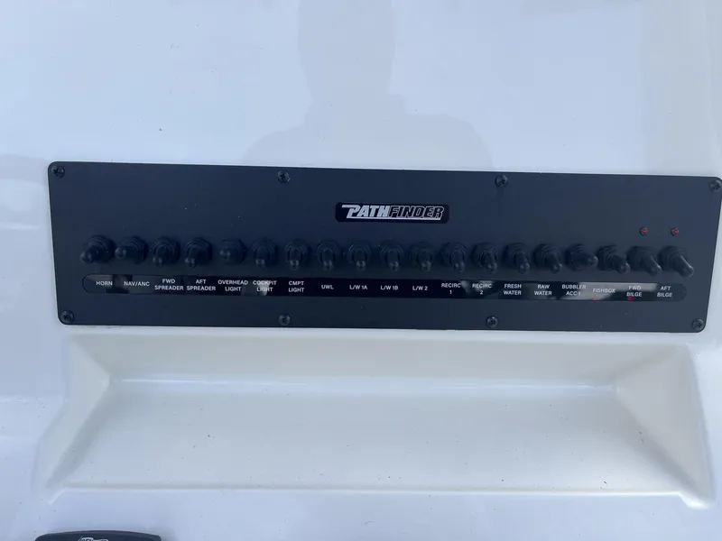 Slide: The Image of Control panel of 2024 Pathfinder 2400 Open boat with labeled switches. - 12