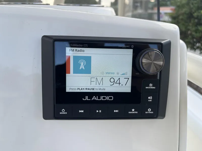 Slide: The Image of JL Audio MediaMaster 105 displaying FM radio on Pathfinder 2400 Open, 2024 model. - 13