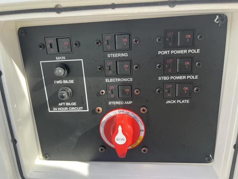 Slide: The Image of Control panel of 2024 Pathfinder 2400 Open boat with switches and red knob. - 14