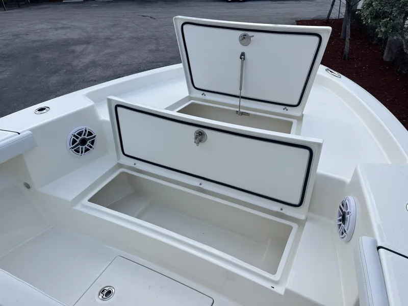 Slide: The Image of 2024 Pathfinder 2400 Open boat storage compartments with open hatches, showcasing interior space. - 16