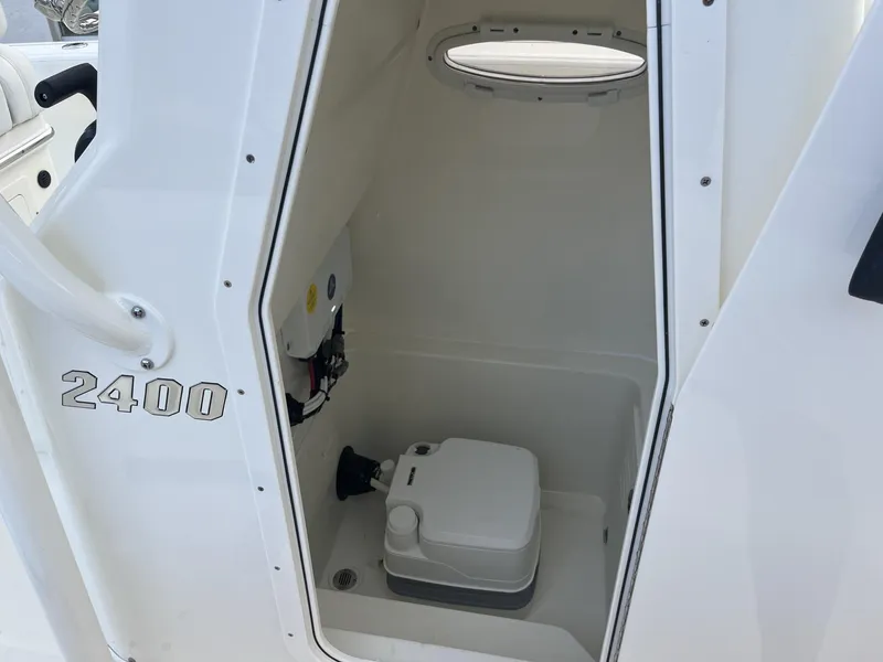 Slide: The Image of 2024 Pathfinder 2400 Open boat interior with compact toilet compartment. - 19