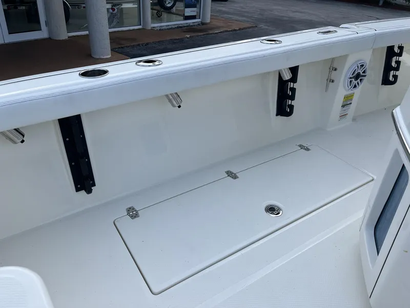 Slide: The Image of 2024 Pathfinder 2400 Open boat interior with rod holders and storage compartment. - 23