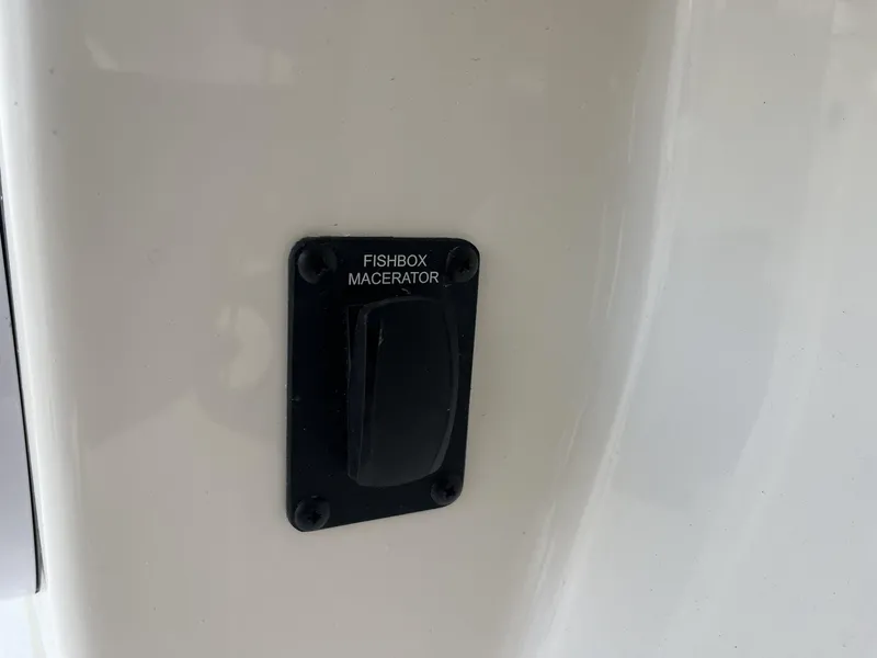 Slide: The Image of 2024 Pathfinder 2400 Open fishbox macerator switch on white surface. - 25