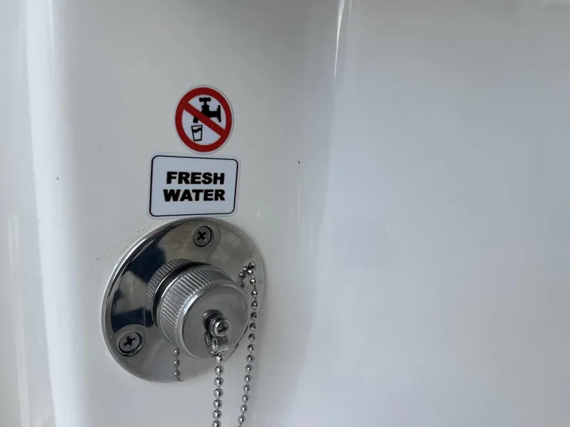 Slide: The Image of Fresh water inlet on 2024 Pathfinder 2400 Open boat with no drinking symbol. - 28