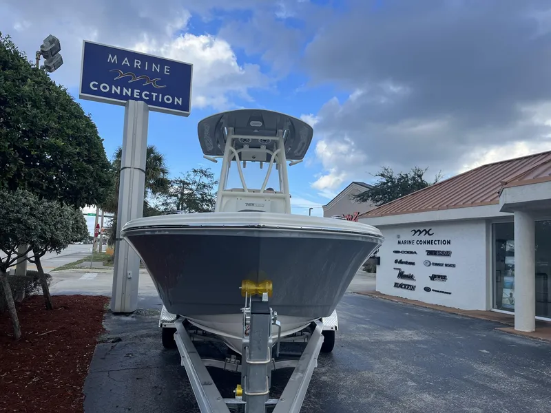 Slide: The Image of 2024 Pathfinder 2400 Open boat at Marine Connection dealership under cloudy sky. - 3