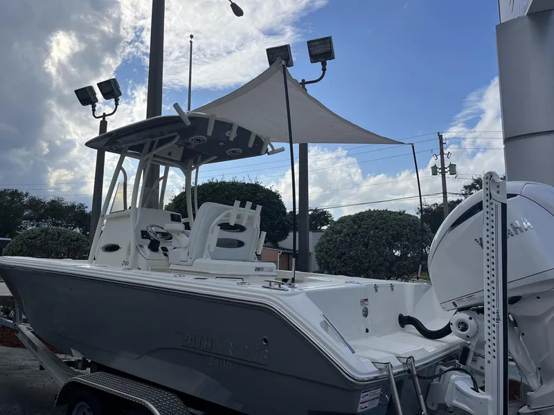 Slide: The Image of 2024 Pathfinder 2400 Open boat with Yamaha engine, displayed outdoors under a cloudy sky. - 31