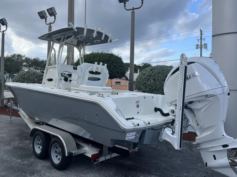 Slide: The Image of 2024 Pathfinder 2400 Open boat with Yamaha engine on a trailer, parked outdoors. - 4