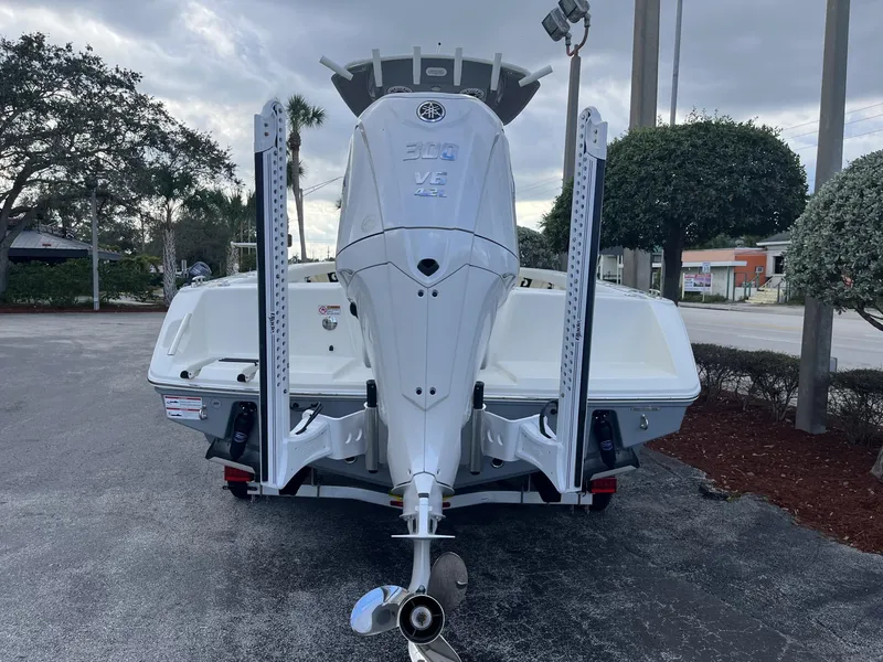 Slide: The Image of 2024 Pathfinder 2400 Open boat with powerful outboard motor, parked outdoors. - 5