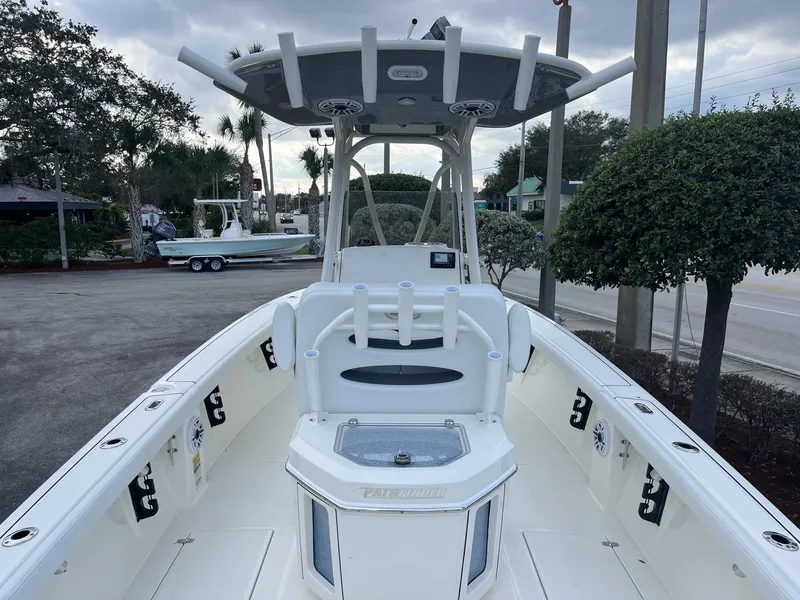 Slide: The Image of 2024 Pathfinder 2400 Open boat, white interior, docked outdoors under cloudy sky. - 9