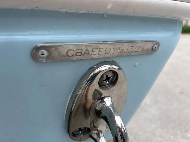 Slide: The Image of 2024 Cobia 350 CC boat hull identification number and metal fitting. - 8