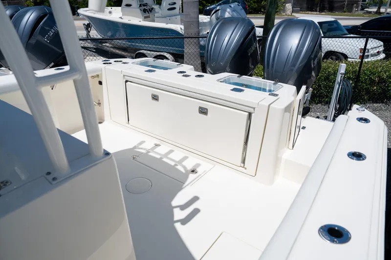 Slide: The Image of 2024 Cobia 320 CC boat deck with dual outboard engines. - 18