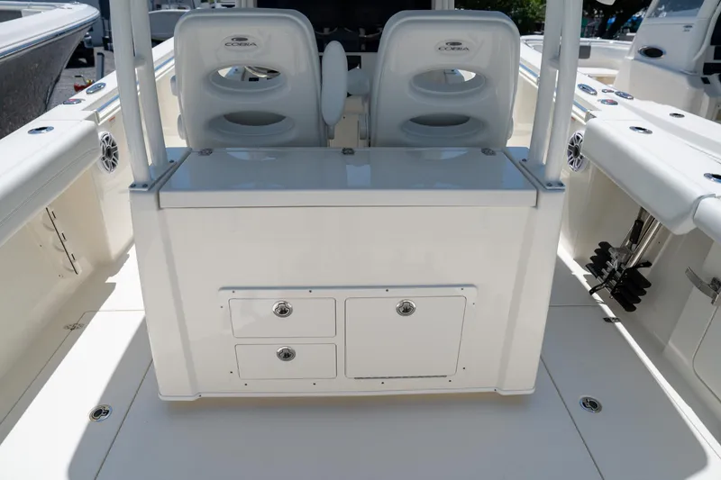 Slide: The Image of 2024 Cobia 320 CC boat interior with seating and storage compartments. - 20