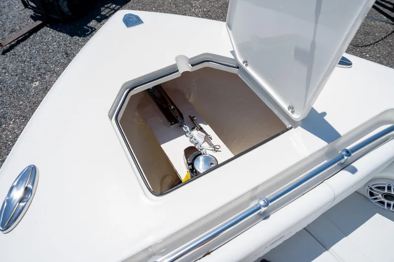 Slide: The Image of Open anchor compartment on 2024 Cobia 320 CC boat, showcasing storage space. - 42
