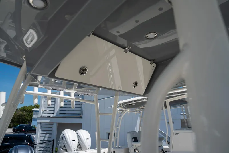 Slide: The Image of 2024 Cobia 320 CC boat interior with storage compartment and modern design. - 48