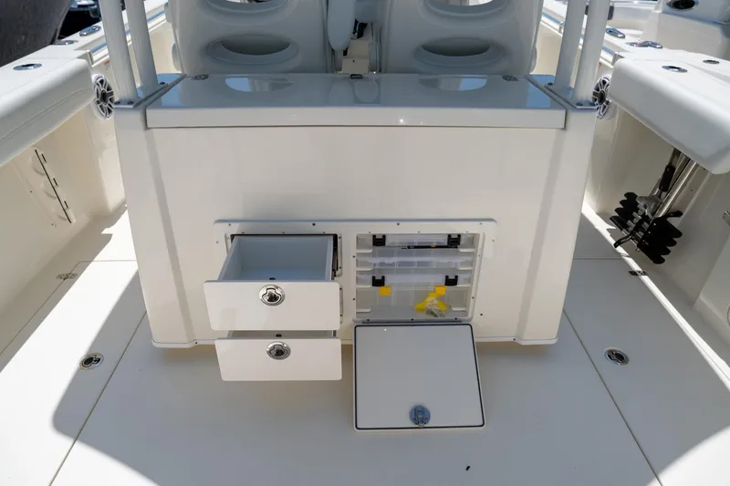 Slide: The Image of 2024 Cobia 320 CC boat interior with open storage compartments and seating. - 22