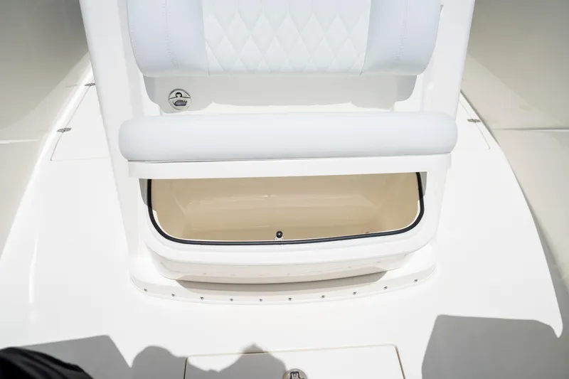 Slide: The Image of 2024 Cobia 320 CC boat storage compartment with cushioned seating. - 43