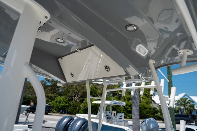 Slide: The Image of 2024 Cobia 320 CC boat's overhead console and lighting detail. - 47