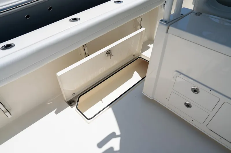 Slide: The Image of 2024 Cobia 320 CC boat storage compartment and drawers, showcasing sleek design and functionality. - 33