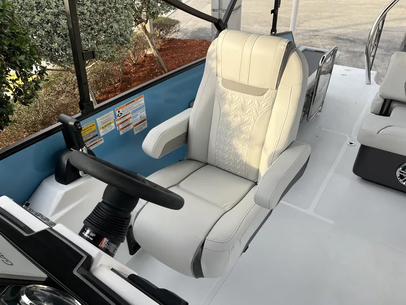 Slide: The Image of 2024 Hurricane FunDeck 2360 SFL OB boat interior with captain's chair and steering wheel. - 18