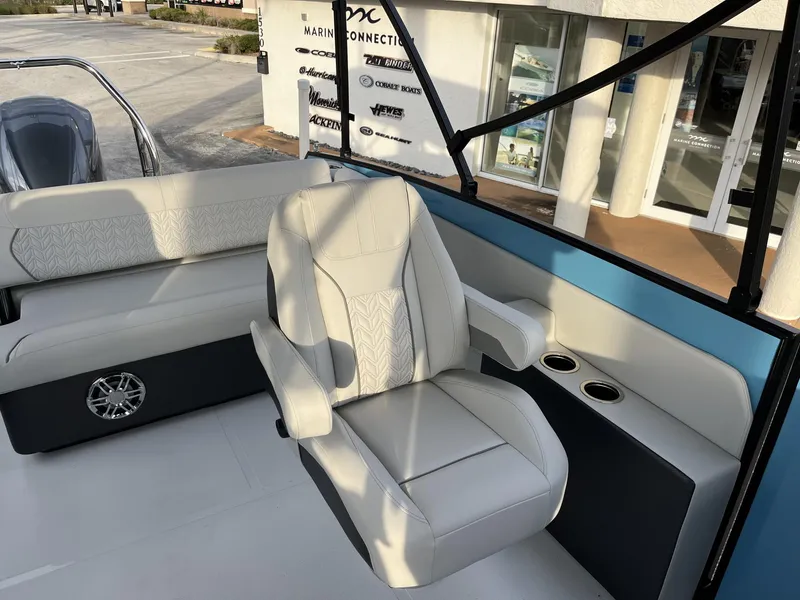 Slide: The Image of 2024 Hurricane FunDeck 2360 SFL OB boat interior with plush seating and cup holders. - 19