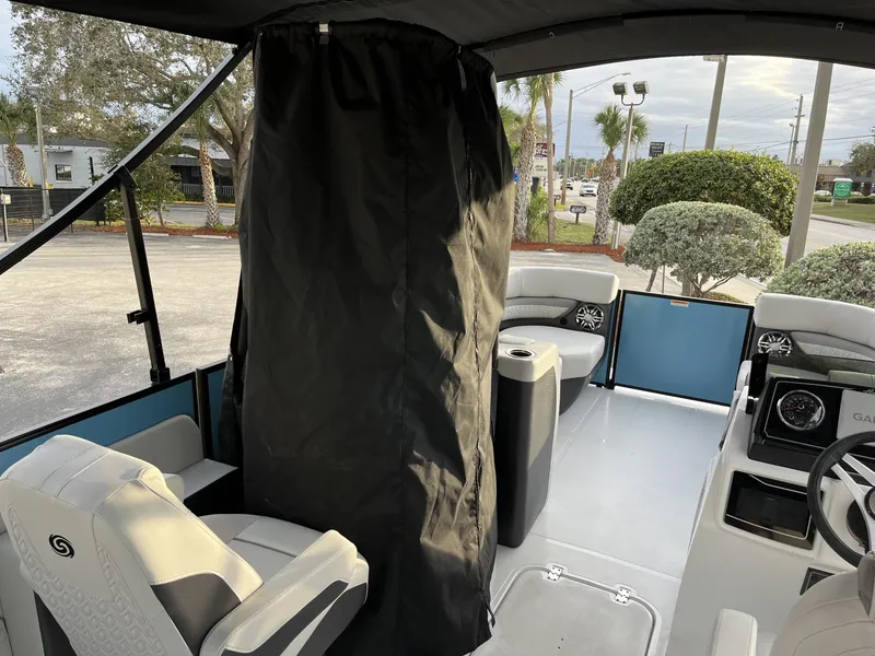 Slide: The Image of 2024 Hurricane FunDeck 2360 SFL OB interior with seating and steering console. - 21