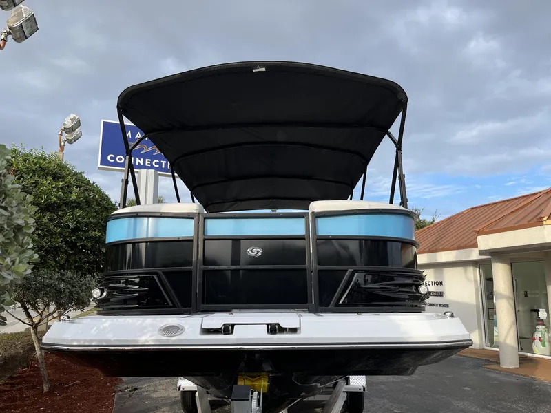 Slide: The Image of 2024 Hurricane FunDeck 2360 SFL OB boat with canopy, displayed outdoors. - 4