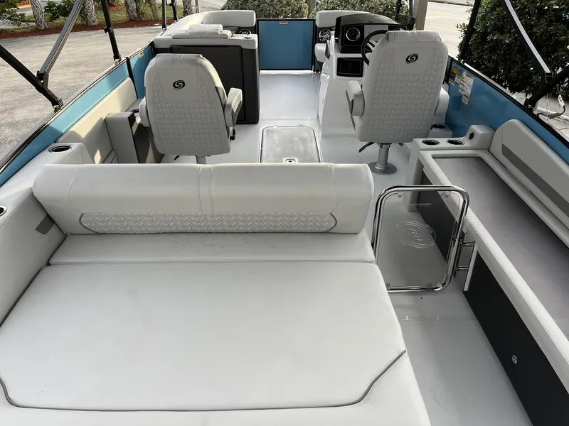 Slide: The Image of 2024 Hurricane FunDeck 2360 SFL OB interior with white seating and modern helm. - 10