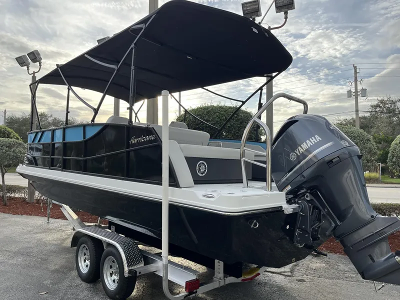 Slide: The Image of 2024 Hurricane FunDeck 2360 SFL OB boat with Yamaha outboard motor on trailer. - 3