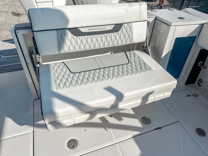 Slide: The Image of 2024 Blackfin 272DC boat seat with white quilted upholstery and sleek design. - 13