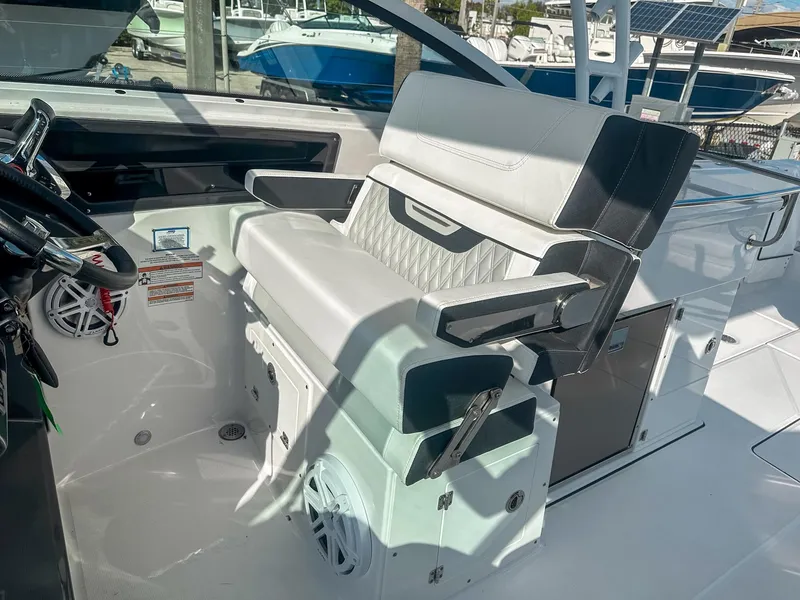 Slide: The Image of 2024 Blackfin 272DC boat interior with luxurious seating and modern steering console. - 19